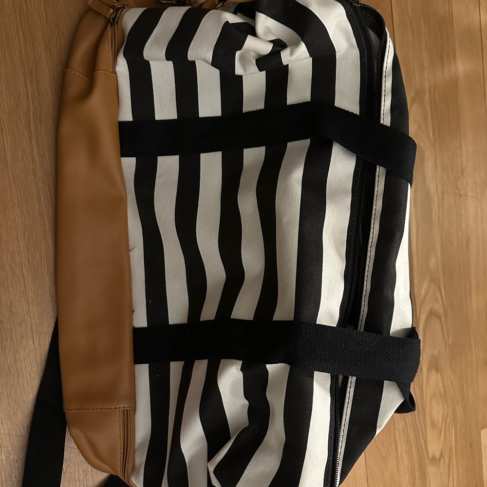 Elegant Black and White Striped Duffel Bag with Tan Accents